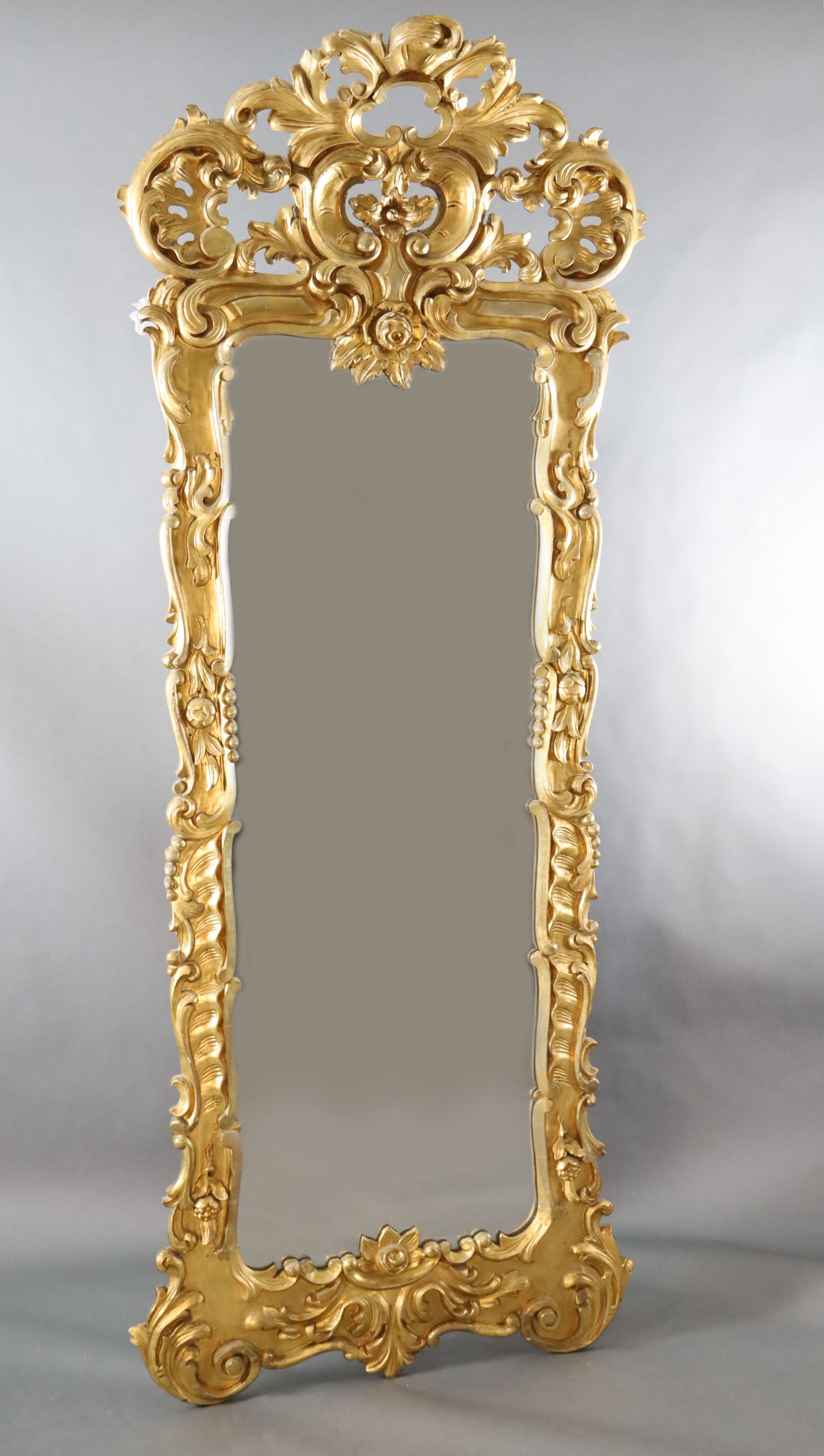 A late 19th century French carved giltwood wall mirror, W.3ft 3in. H.8ft 5in.